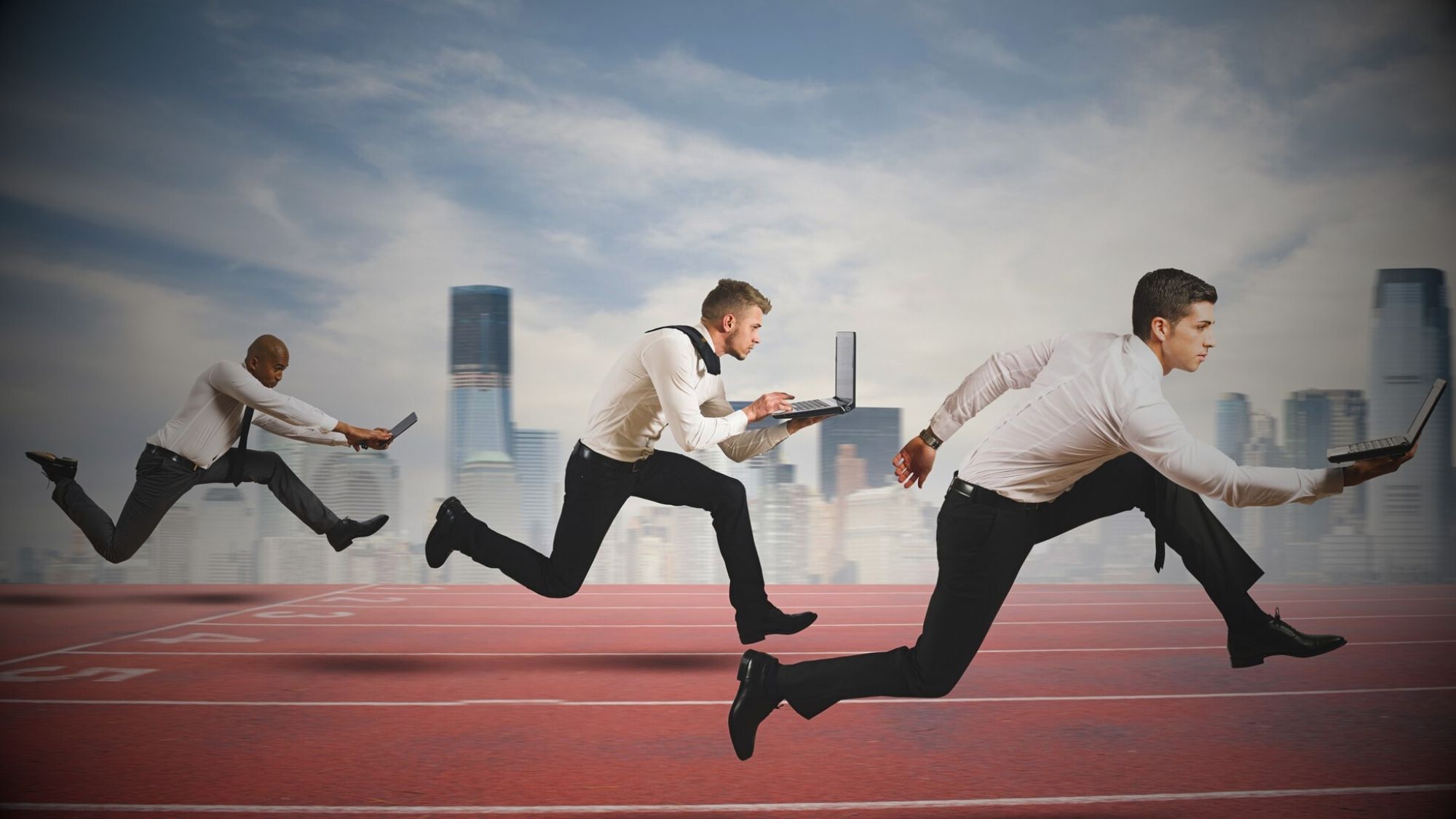Businessmen sprinting on a track with laptops, showcasing the fast-paced nature of beating your competitor in google search